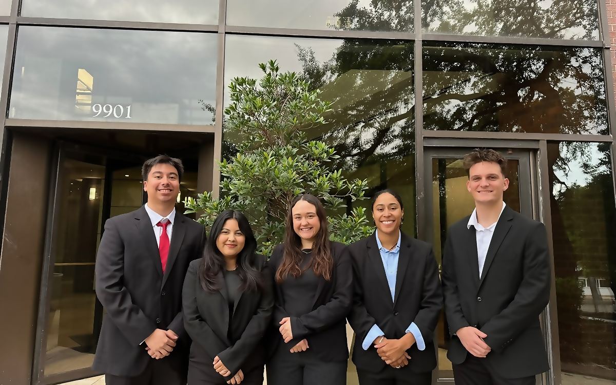 Five Social Standard team members outside a client office building