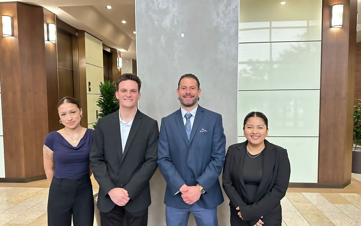 Four Social Standard team members together in the lobby of a Chicago office building