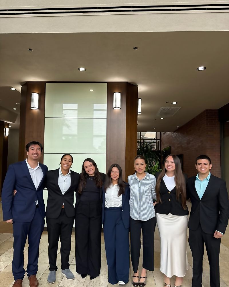 Seven Social Standard team members together in a hotel lobby